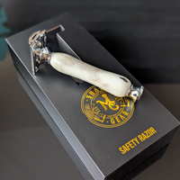 top view of a hand-crafted safety razor with an antler handle from mc shave gear with packaging