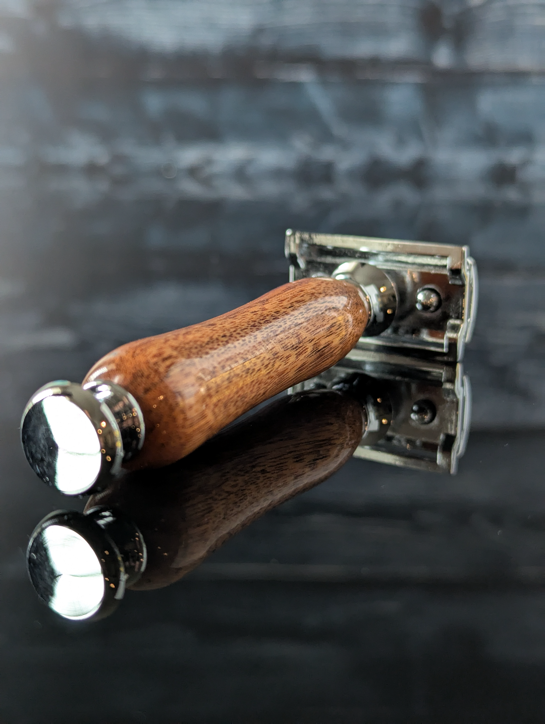 detail view of a hand-crafted safety razor with a mesquite handle from MC Shave Gear