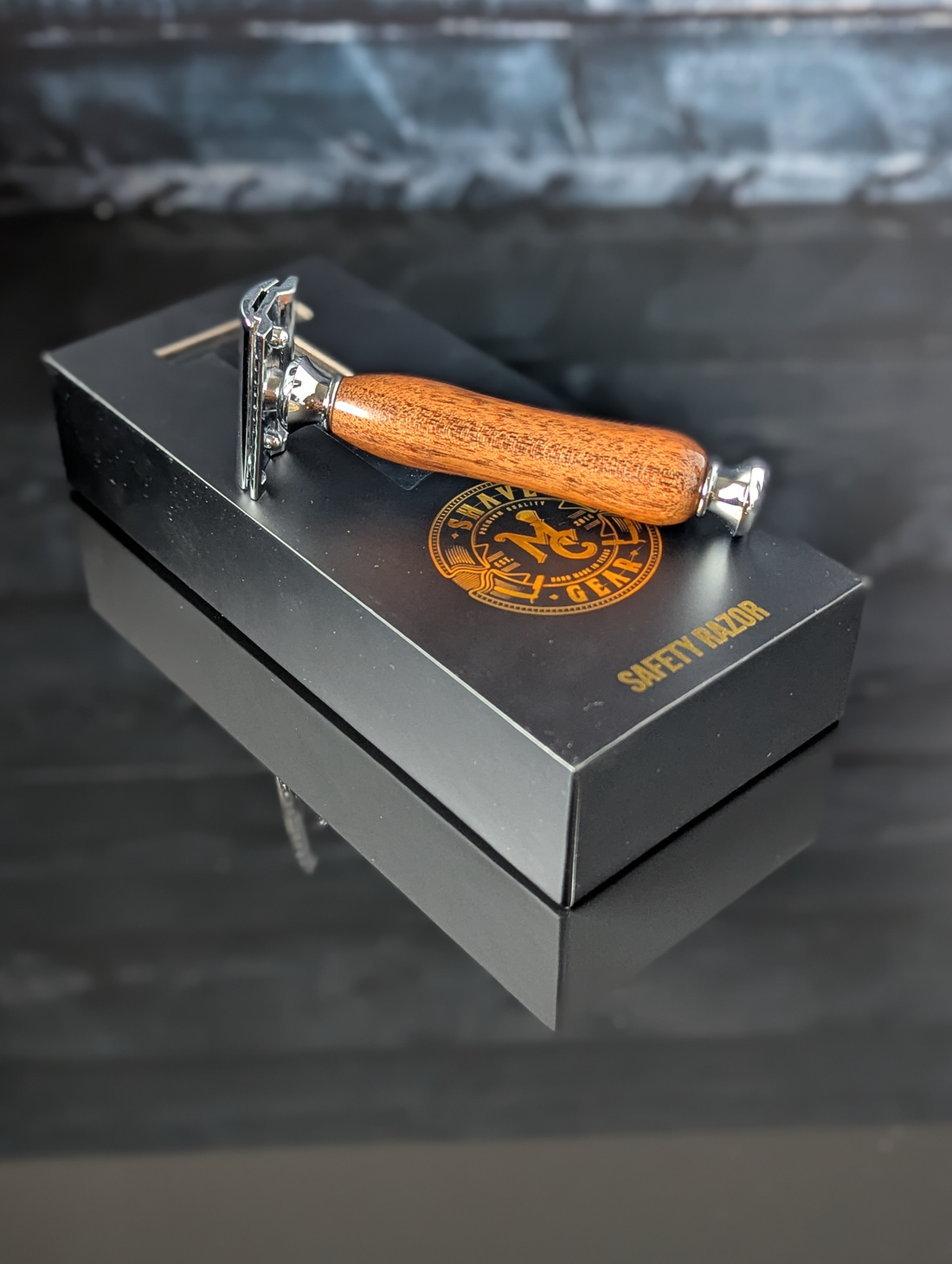 top view of a hand-crafted safety razor with a mesquite handle from MC Shave Gear with packaging box