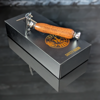 top view of a hand-crafted safety razor with a mesquite handle from MC Shave Gear with packaging box