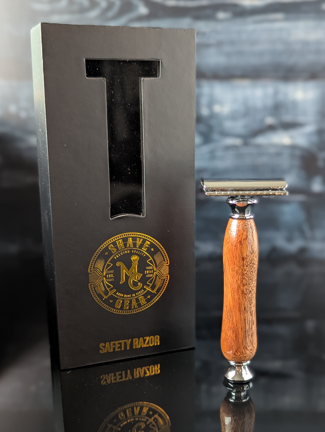 front view of a hand-crafted safety razor with a mesquite handle from MC Shave Gear with packaging box