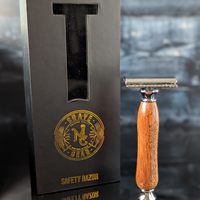 front view of a hand-crafted safety razor with a mesquite handle from MC Shave Gear with packaging box